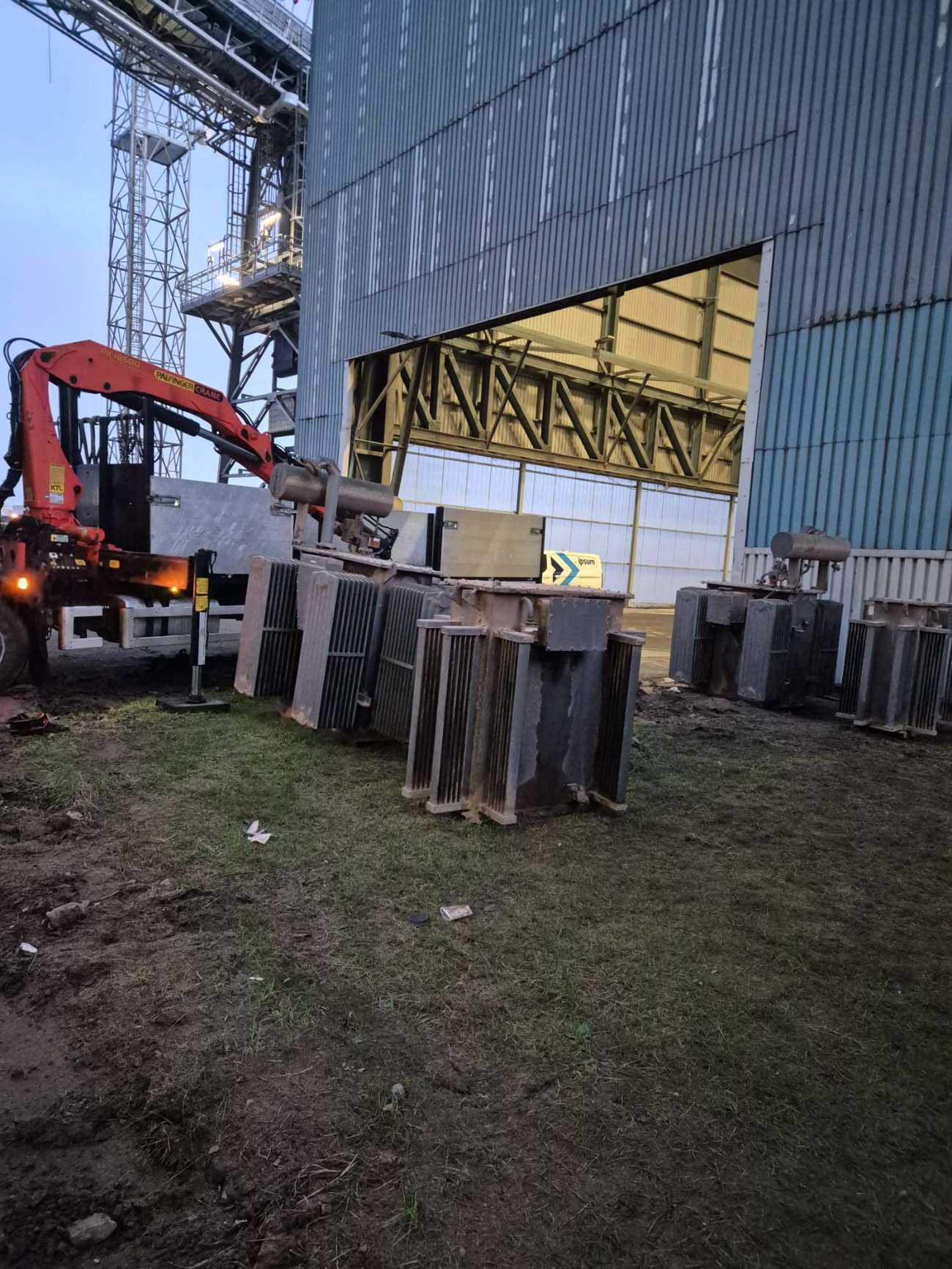 Decommissioned oil-filled transformers staged on site